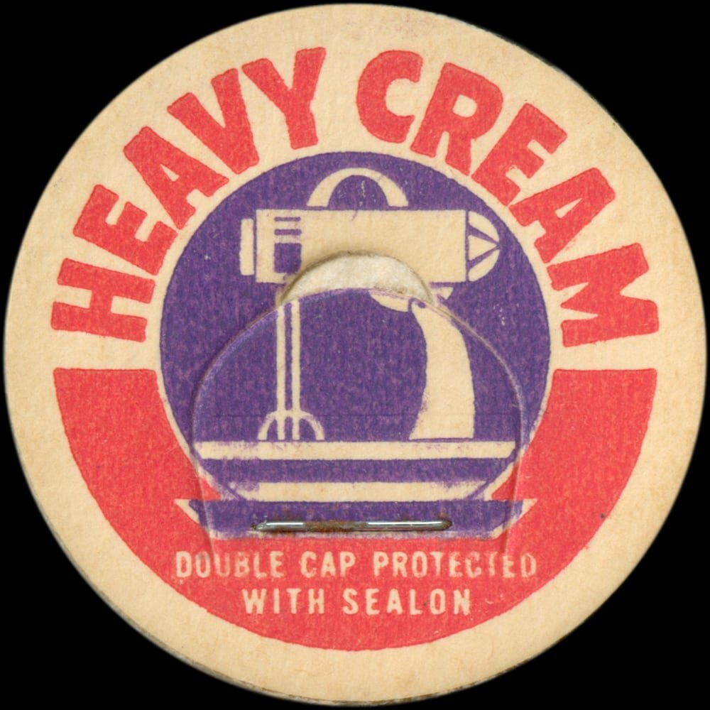 Vintage circular dairy cap with printed typographic milk advertising and a metal pull tab.