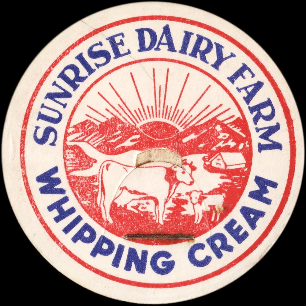 Sunrise Dairy Farm whipping cream cap with red-and-blue pastoral cow illustration.