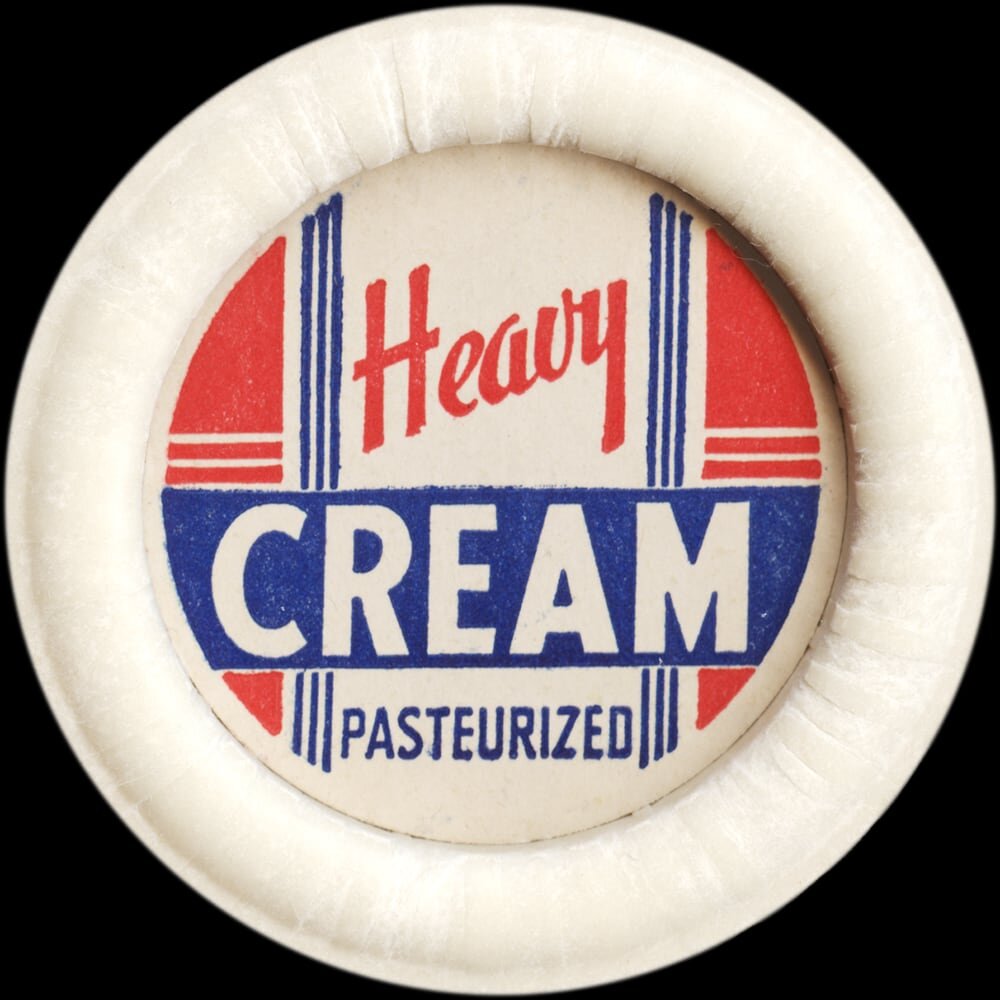Vintage circular dairy cap with printed typographic milk advertising and a metal pull tab.