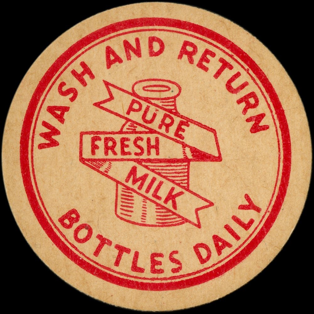 Vintage circular dairy cap with printed typographic milk advertising and a metal pull tab.