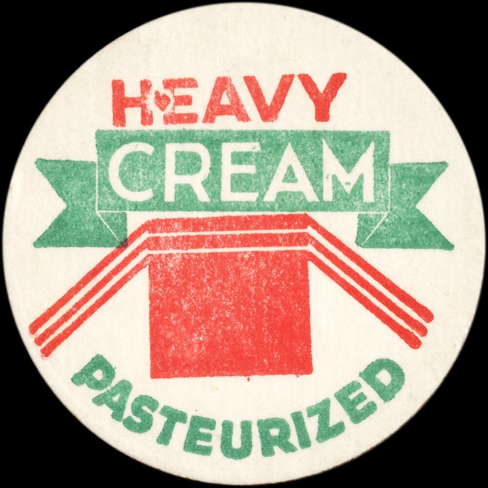 Vintage circular dairy cap with printed typographic milk advertising and a metal pull tab.