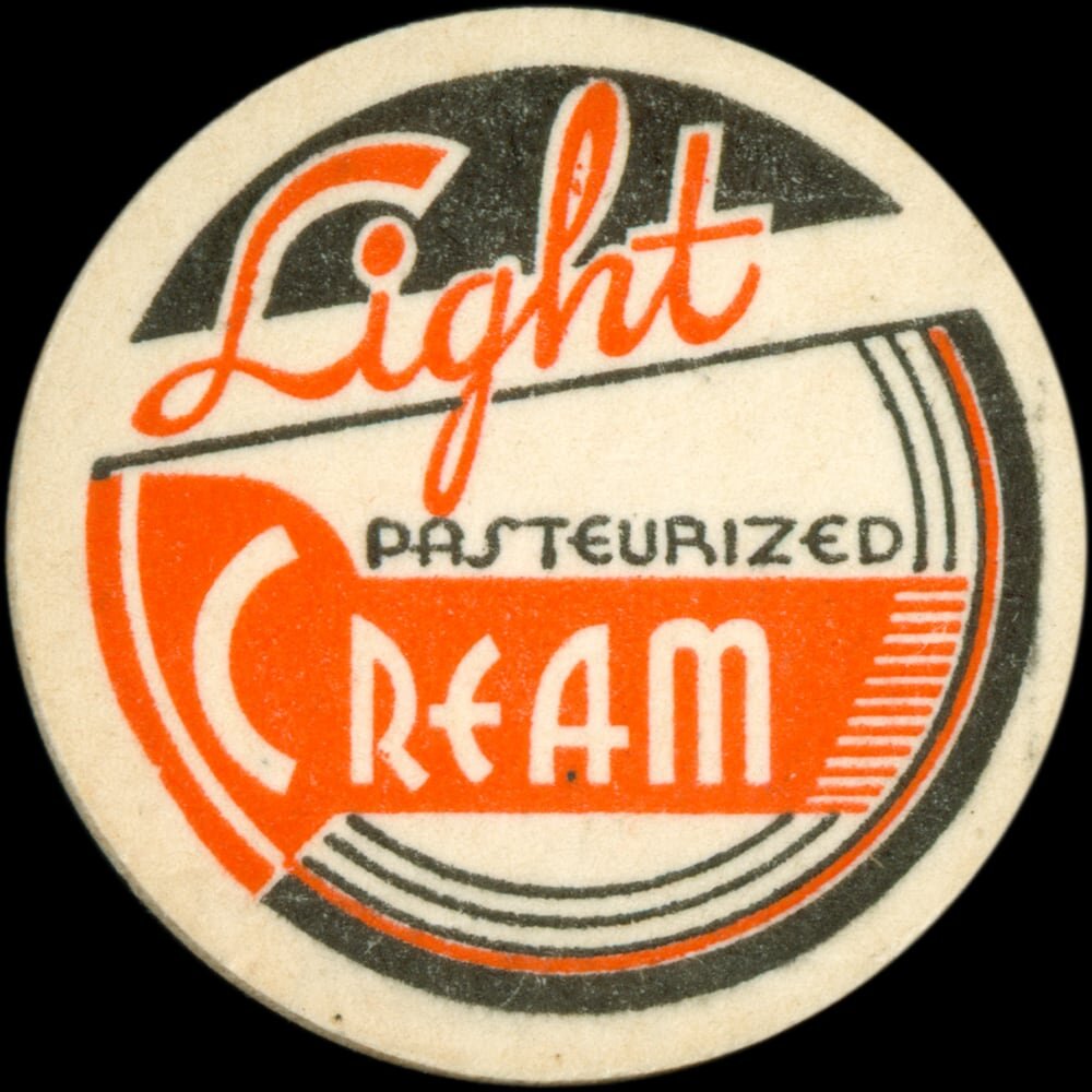 Vintage circular dairy cap with printed typographic milk advertising and a metal pull tab.