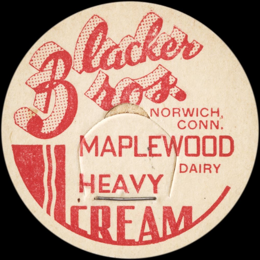 Vintage circular dairy cap with printed typographic milk advertising and a metal pull tab.