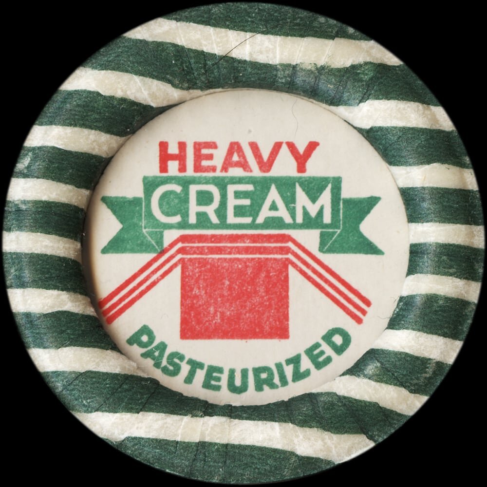 Vintage circular dairy cap with printed typographic milk advertising and a metal pull tab.