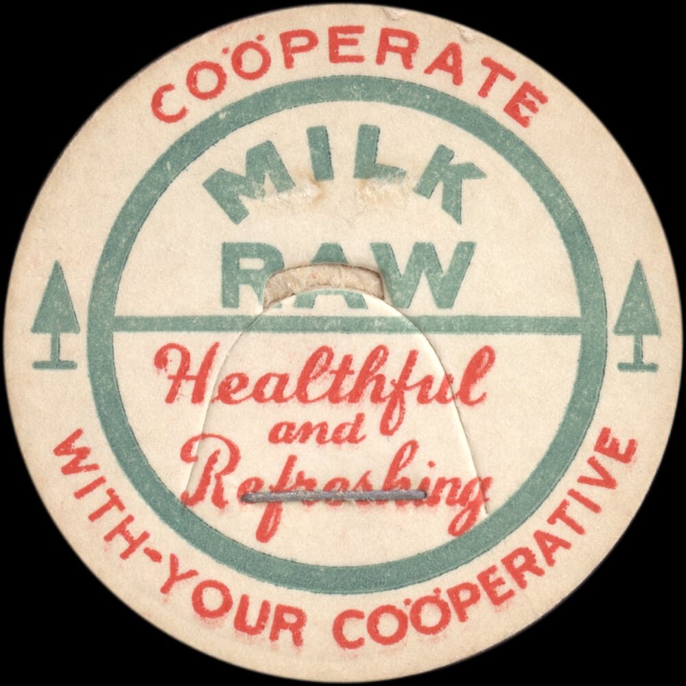 Vintage circular dairy cap with printed typographic milk advertising and a metal pull tab.