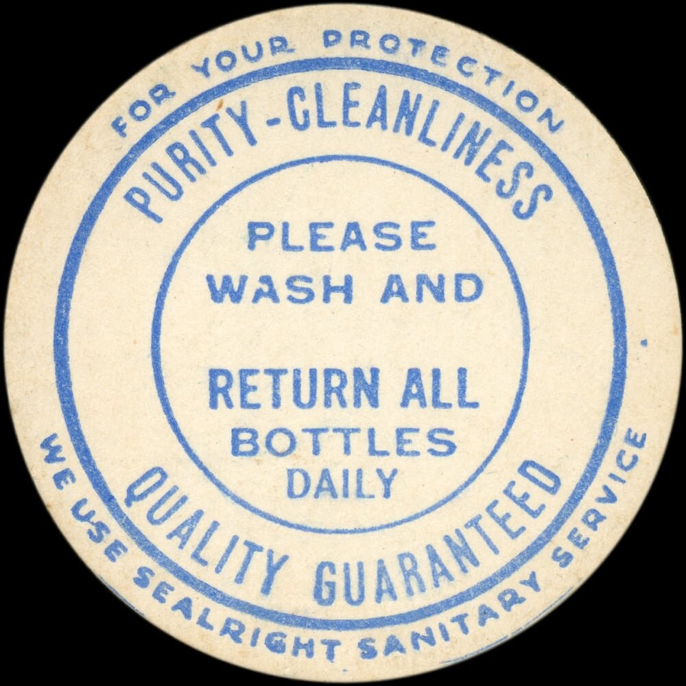 Vintage circular dairy cap with printed typographic milk advertising and a metal pull tab.