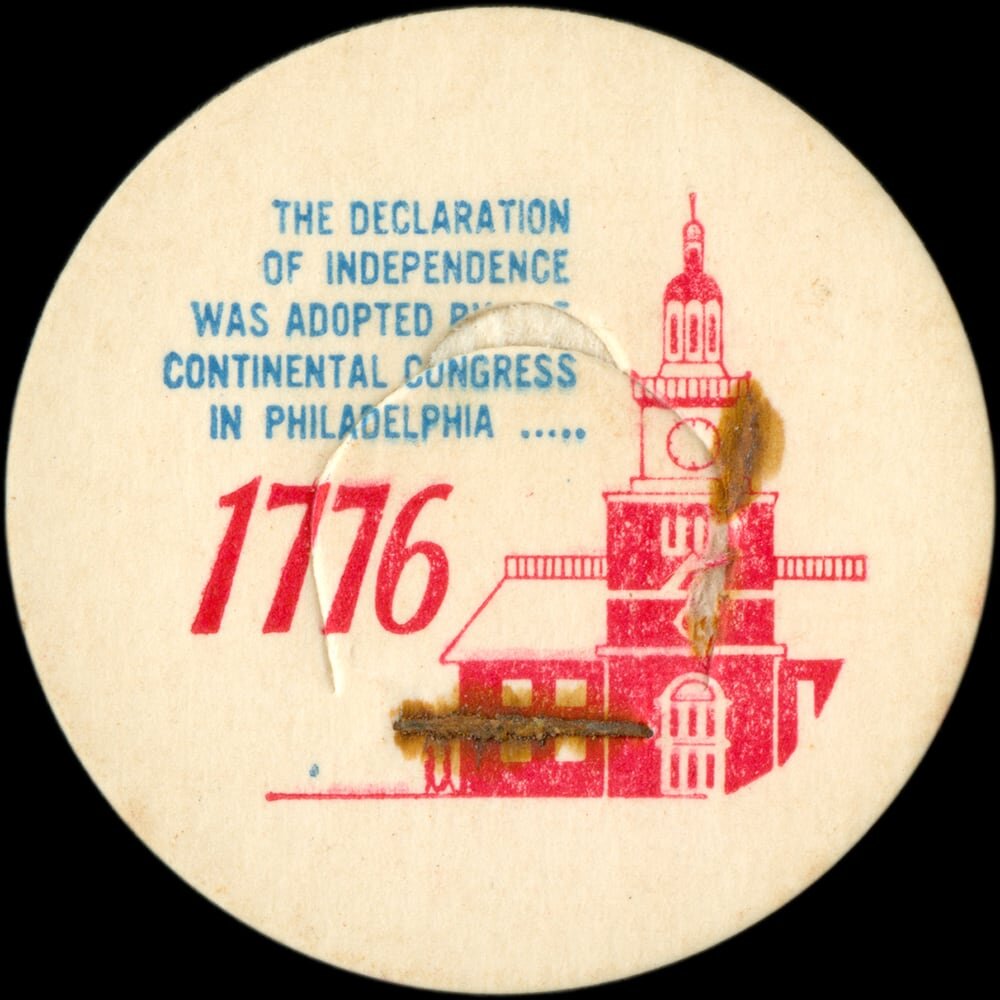 Vintage circular dairy cap with printed typographic milk advertising and a metal pull tab.