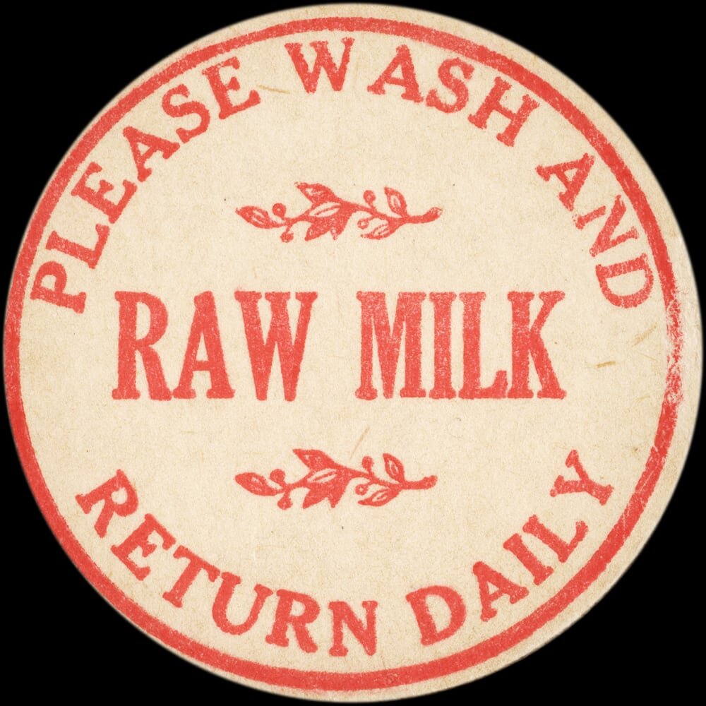 Vintage circular dairy cap with printed typographic milk advertising and a metal pull tab.