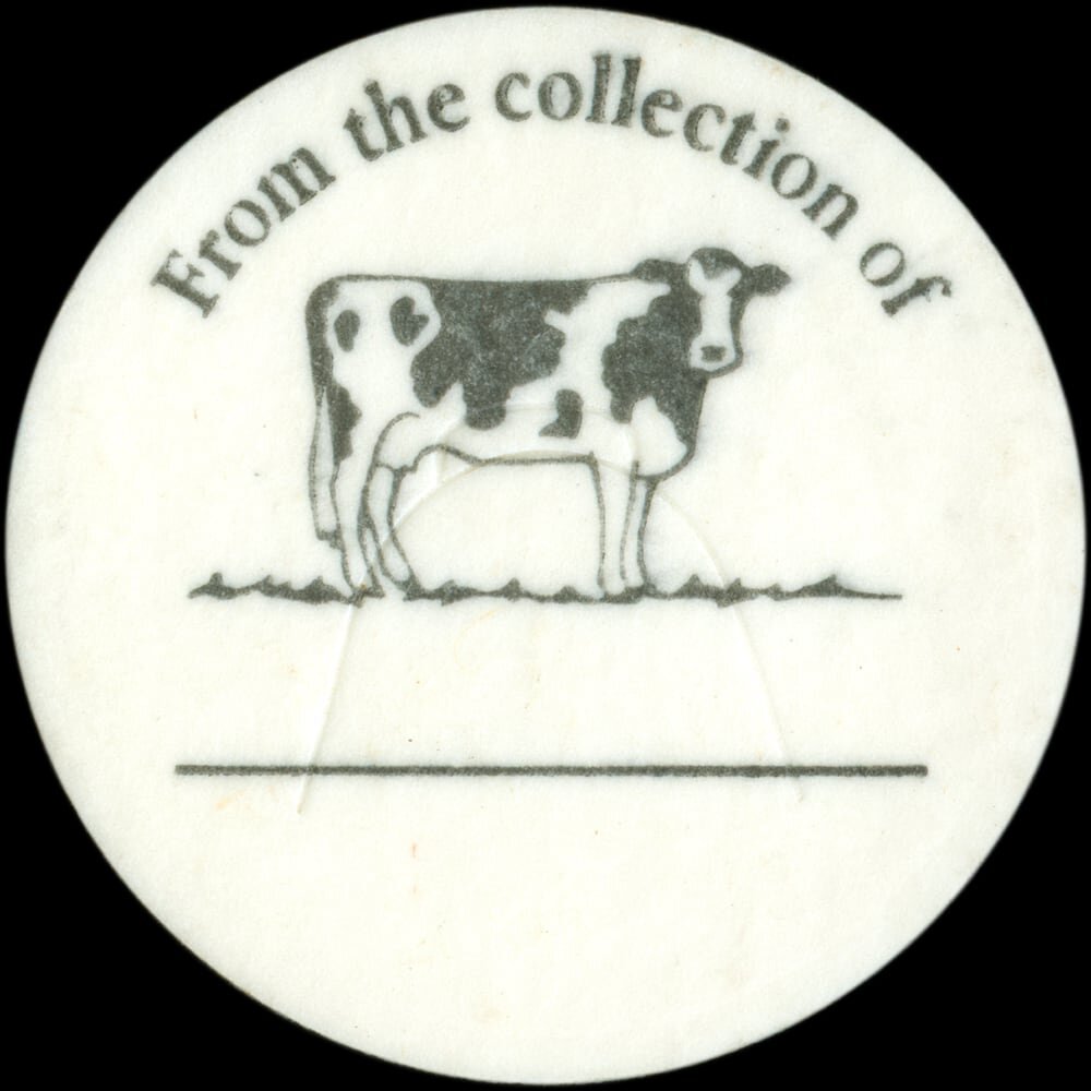 Vintage circular dairy cap with printed typographic milk advertising and a metal pull tab.