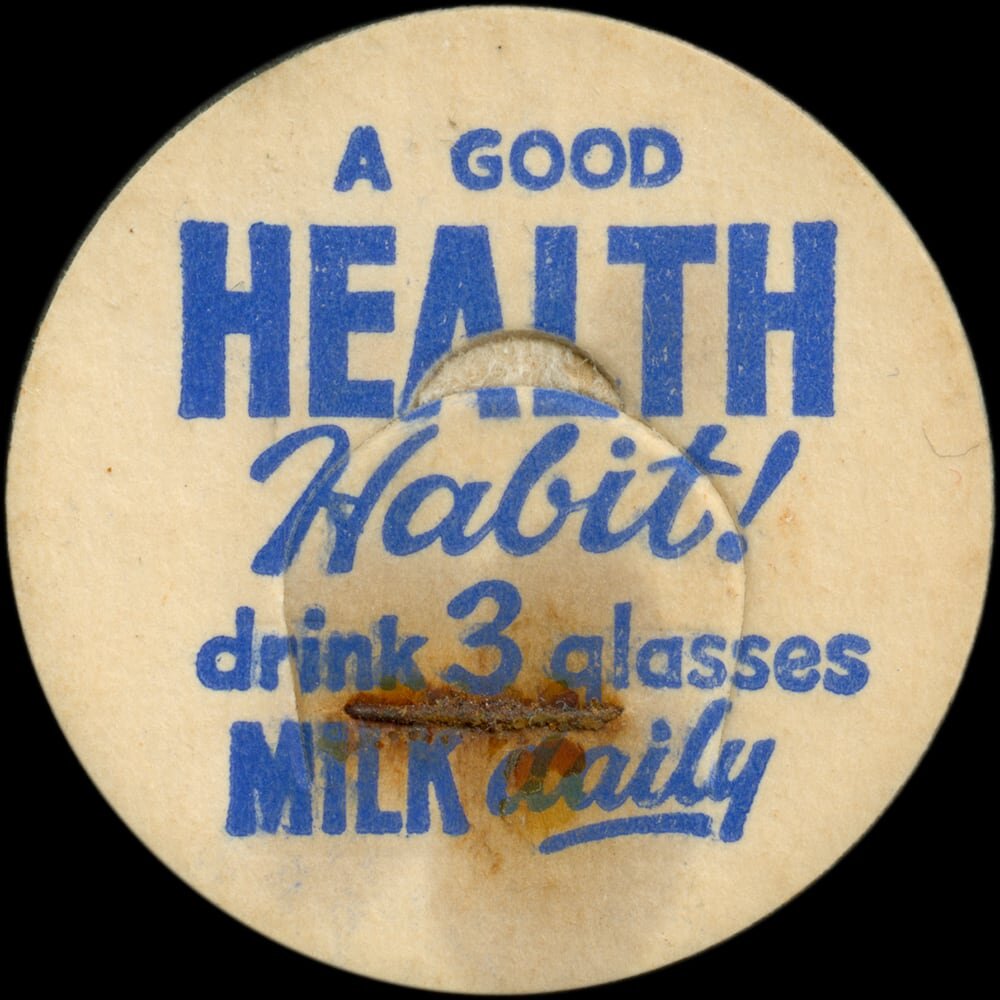 Vintage circular dairy cap with printed typographic milk advertising and a metal pull tab.
