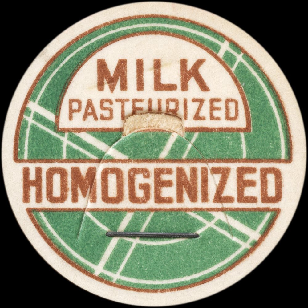 Vintage circular dairy cap with printed typographic milk advertising and a metal pull tab.