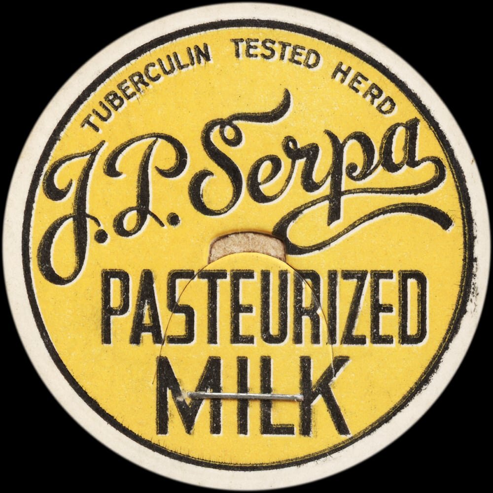 Vintage circular dairy cap with printed typographic milk advertising and a metal pull tab.